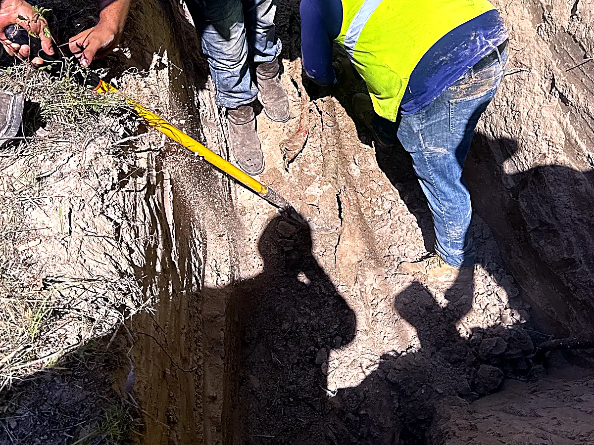 Crew with PPE working in a shored trench